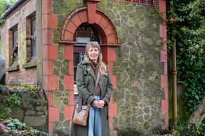 Loz Samuels outside the world's smallest theatre building in Malvern, Worcestershire.