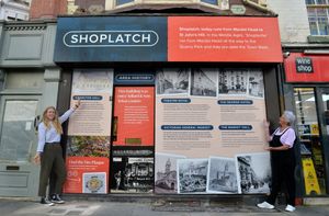 Maggie Love, a local historian who curated the panel, and Emma Molyneux with the window display