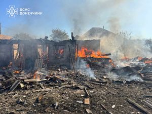 A fire in private houses destroyed in a Russian air raid in the Donetsk region of Ukraine