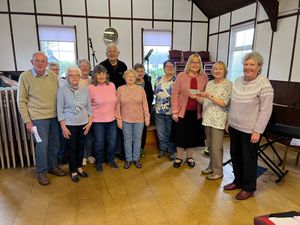 Vera Buckler, leader of the Bracken Trust Singers, accepted the cheque from Cynthia Shepperd on behalf of the Trust. Also in the photo are Ann Lloyd, (Chair) and Karen Bennett (Vice Chair) of Powys W.I’s and some members of the Singers who were present on St. David’s Day.