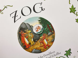 The design features Zog flying, complete with tiny wings and a determination to earn a golden star at Dragon School.