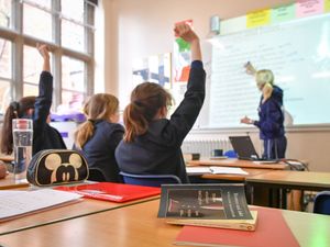 A teacher and students in a classroom.