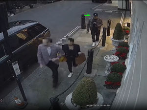 Video still of plain clothes officers walking along a street in Mayfair being followed by a man