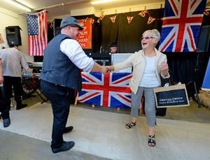 Eighty-one-year-old shopper Joan Fellows dances with trader Steven Bridgwater