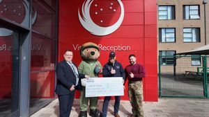Headteacher Mike Smith, Regional Manager Dean Williams and Squadron Leader Luke Horobin receiving cheque for Help for Heroes Charity 