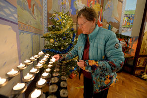Maria Phillips lights a candle
