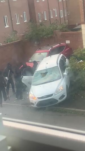 In the footage, a group of masked men are seen attacking the white Ford and the three men inside it