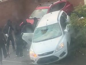 Supporting image for story: The shocking moment masked thugs launch attack with weapons on car on a leafy Bilston street