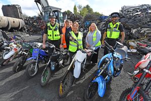 Pictures next to the soon to be scrapped bikes is, Council leader Kerri Carmichael with the team.