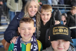 Dawn and George (back) pose for pictures with two young baggies fans - one of whom is called Astle in honour of Baggies legend Jeff Astle