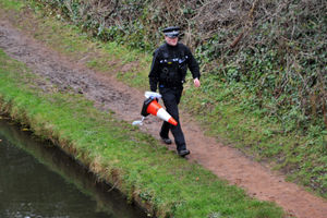 A police officer at the scene next to the Shropshire Union Canal