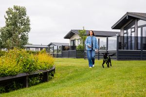 Alex Jones walks her dog Scout around the lake at Unity Beach's Country Club.
