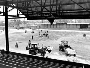 Volunteers with tractors battle to clear the Gay Meadow pitch