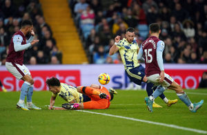 Leeds United's Rodrigo Moreno collides with Aston Villa goalkeeper Emiliano Martinez