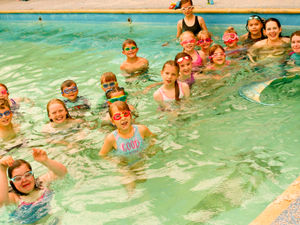 Supporting image for story: Aquatic fun as children swim with mermaid
