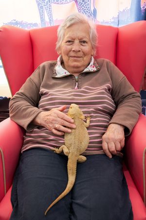 Shirley Latham, 84 (Resident) with “Squishy” a Bearded Dragon