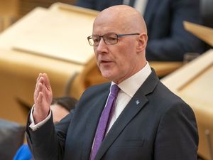 John Swinney gesturing with his hand as he speaks in Holyrood