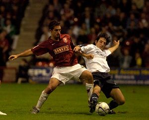 Kris Taylor battles for possession against Bolton.