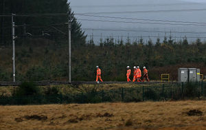 Network rail engineers walk along the track near to where an Avanti West Coast train, travelling from Glasgow to London Euston sation, derailed, near Shap, north west England on November 3, 2025.