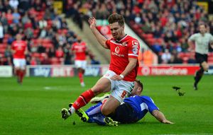 Walsall's Tom Bradshaw is taken down by Chesterfields Ian Evatt.