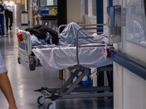 A patient bed on an NHS hospital ward in England (PA)