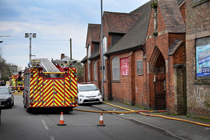 Firefighters at the scene of a fire on Birchills Street, Walsall, where a wooden building caught fire behind a church