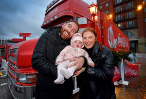 Ronan Sweeney, Sophie Guest and baby Orla braved the rain to see the famous festive truck