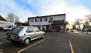 A period VW Golf parked outside the Coach and Horses in West Bromwich for filming. Modern vans can be seen in the background, though.