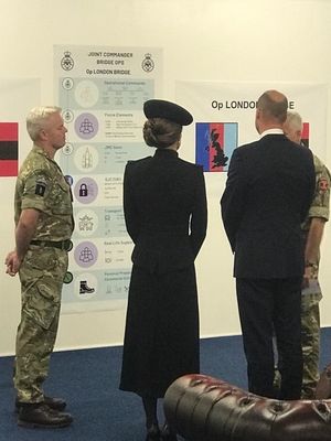 Patch, left, and Ben Rehaal, brief the Prince and Princess of Wales