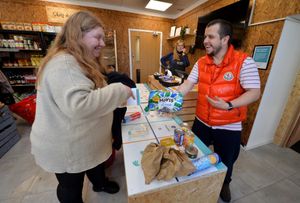 The opening of the 'All Nations Community Grocery' in Telford. Pictured is staff member, Paul Westbury along with customer, Dawn Wilkin