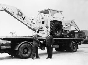 In 1964, JCB exported its first machine to the US. Mr Bamford is pictured, left  