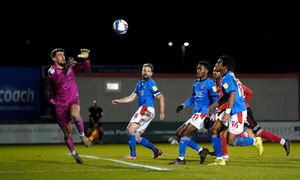 Lincoln City's Alex Palmer saves a shot on goal