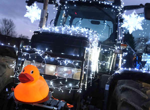 A rubber duck on one of the large tractors decked out in silver lights at Kington tractor run