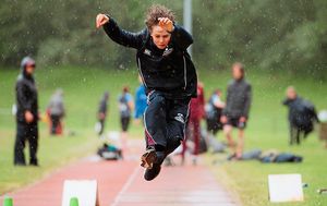 Catop Pugsley takes a leap in the Junior Boys Long Jump competition 
