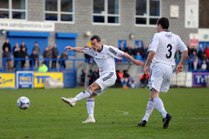 Matty McGinn of AFC Telford United watches as Shaun Whalley of AFC Telford United lets fly to score to make it 1-0