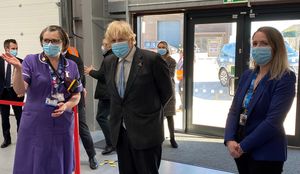 Prime Minister Boris Johnson chats to staff and volunteers during a visit to Tunstall Covid-19 Vaccination Centre