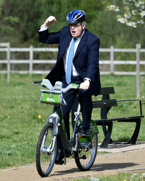 Prime Minister Boris Johnson rides a bike along the towpath in Stourbridge