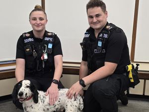 Surrey Police officers Ellen Francis and Ewan keen with Daisy the cocker spaniel