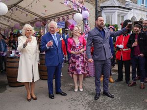 Supporting image for story: Camilla ties ribbon in nod to domestic abuse victims during EastEnders cameo