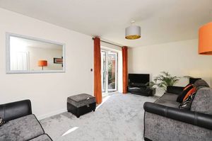 The generous sized living room has French doors leading to the garden