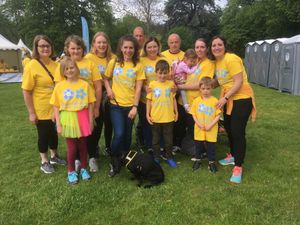 Julie Davies, holding dog lead, and family