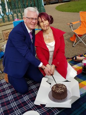 Dave and Karen cut their wedding cake at the Quarry park in Shrewsbury