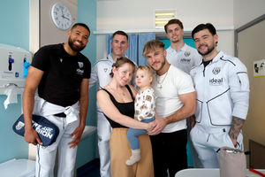 Players from the team with two-year-old Noah