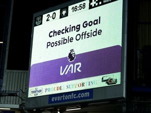 A big screen showing a VAR check