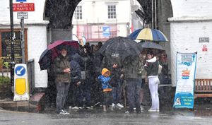 Visitors to the Bridgnorth Italian Moto Fest brave the horrendous downpours to view the cars on show