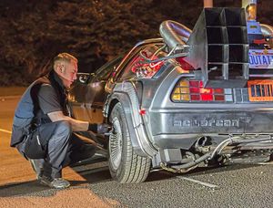 Dave Morgan repairs the flat tyre on the DeLorean to allow it to continue on its way Back to the Future