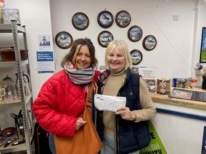 Founder of The Write Word, Stella Ashbrook with Sue Sealy at The Rural Charity handing over £1000 for their funds.