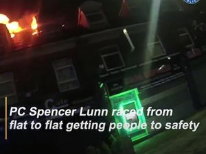 Supporting image for story: WATCH: Officer runs into burning building to rescue families