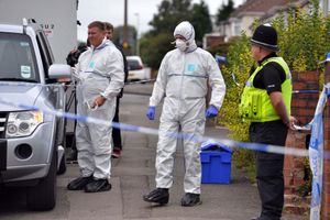 Forensic officers outside the house on Cradley Road