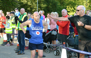 Jim Hussey crosses the finishing line ........  .............................